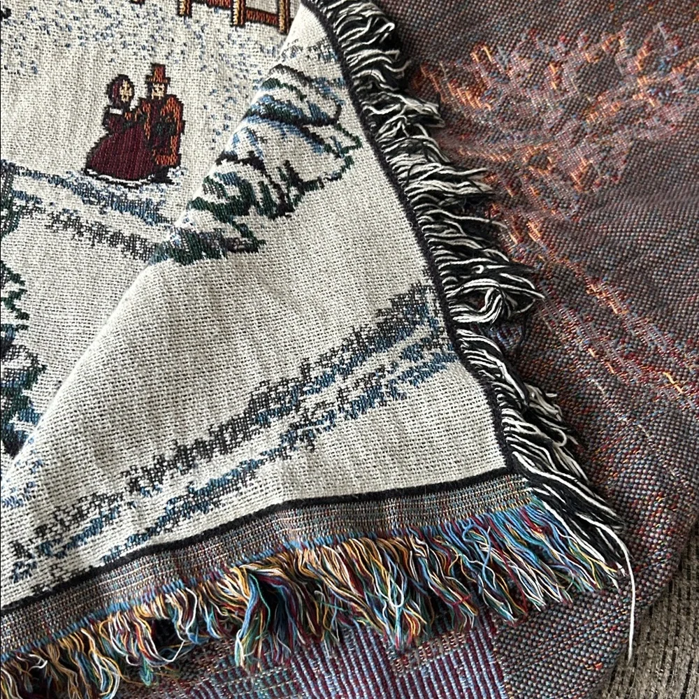 woven tapestry throw blanket featuring a winter village scene fringe edges